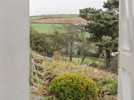 A view of the landscape with trees and a gate at The Old Studio in Penzance