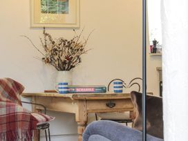 A dining room with a table and flowers at The Old Studio in Penzance