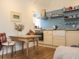 A kitchen with table and chairs at The Old Studio in Penzance