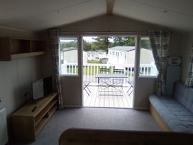 A living room with a sofa and a television at Caravan in Newquay