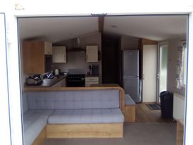 A kitchen with a sofa and appliances at Caravan in Newquay