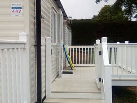 An outdoor area with decking and colorful boards at White Acres Holiday Park in Newquay