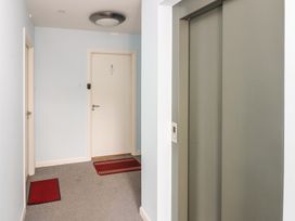 A hallway with an elevator and door at Mill Wharf in Berwick-upon-Tweed