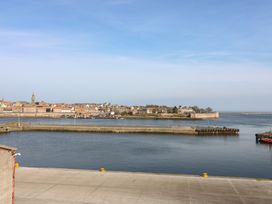 A view of water and buildings from a pier at Mill Wharf in Berwick-upon-Tweed