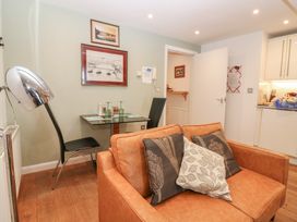 A living room with a sofa, table, and chair at Mill Wharf in Berwick-upon-Tweed