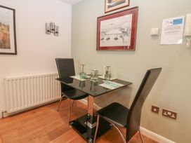 A dining area with a table and two chairs at Mill Wharf in Berwick-upon-Tweed