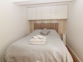A bedroom with a bed and cabinets at Mill Wharf Berwick-upon-Tweed
