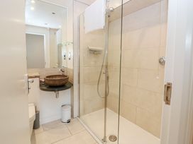 A bathroom with a shower, sink, and toilet at Mill Wharf in Berwick-upon-Tweed