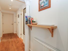 A hallway with a wooden shelf and books at Mill Wharf in Berwick-upon-Tweed