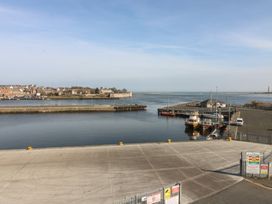 A harbor with boats and a pier at Mill Wharf Berwick-upon-Tweed