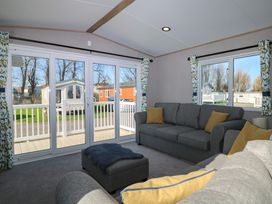 A living room with a sofa and ottoman at 0028 South Beach 