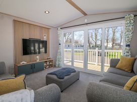 A living room with a television and seating area at 0028 South Beach