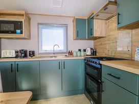 A kitchen with appliances and cabinets at 0028 South Beach