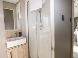 A bathroom with a shower and sink at 0028 South Beach