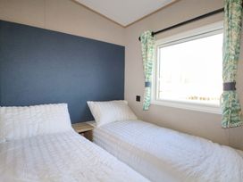 A bedroom with two beds and a window at 0028 South Beach