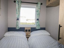 A bedroom with two beds and a window at 0028 South Beach