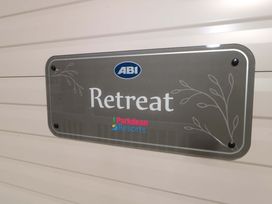 A sign displaying ABI Retreat at Parkdean Resorts