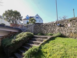 A set of stairs leading to a house surrounded by grass at 3 The Elms in Salcombe
