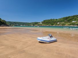 A beach with a boat on the sand at 3 The Elms in Salcombe