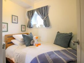 A bedroom with a bed and wall art at 3 The Elms in Salcombe