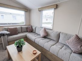 A living room with a sofa and table at Hadrian's Rest in Wigton
