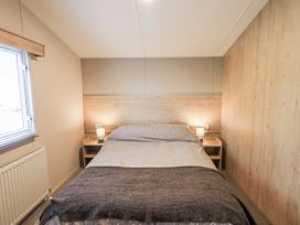 A bedroom with a bed and bedside table at Hadrian's Rest in Wigton