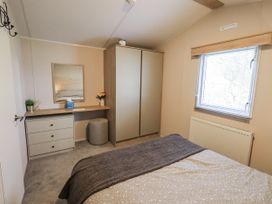 A bedroom with a bed and desk at Hadrian's Rest in Wigton