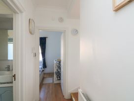 A hallway with a clock and dresser at 4 The Elms Salcombe