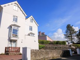 A building with windows and a fence at 4 The Elms Salcombe