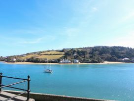 A view of water with a boat and hills in the background at 4 The Elms Salcombe