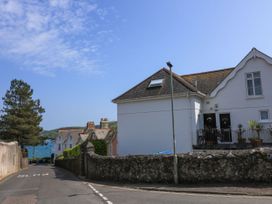 A view of houses and a road with an ocean in the background at 4 The Elms Salcombe