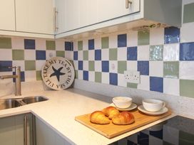 A kitchen counter with croissants and cups at 4 The Elms Salcombe