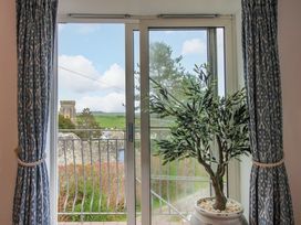 A living room window with a view and a plant at 4 The Elms in Salcombe