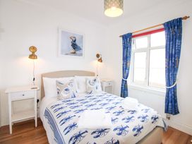A bedroom with a bed and bedside table at 4 The Elms in Salcombe