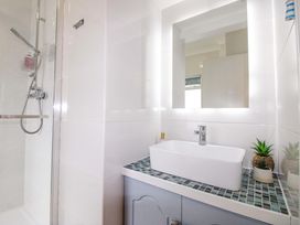 A bathroom featuring a shower, sink, and plants at 4 The Elms in Salcombe