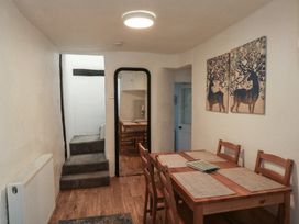 A dining room with a table and chairs at The Cottage in Budleigh Salterton