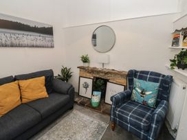 A living room with a sofa and armchair at The Cottage in Budleigh Salterton