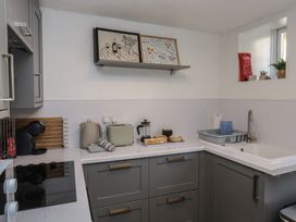 A kitchen with a sink and appliances at The Cottage Budleigh Salterton