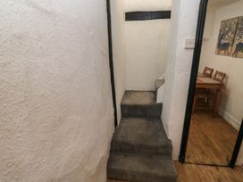 A staircase and a dining area in a hallway at The Cottage Budleigh Salterton