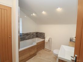A bathroom featuring a bathtub, toilet, and sink at The Cottage in Budleigh Salterton