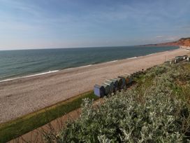 A beach with huts and a sea view at The Cottage Budleigh Salterton