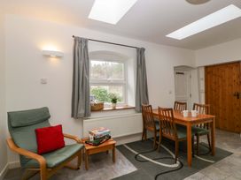 A dining room with a table and chairs at Castle Rag in Lydney