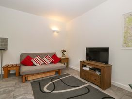 A living room with a sofa and television at Castle Rag in Lydney