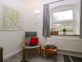 A snug with a map on the wall and an armchair at Castle Rag in Lydney