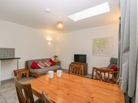 A snug with a table and chairs and a sofa at Castle Rag in Lydney
