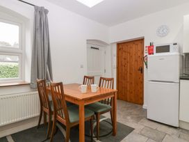 A kitchen with dining table and chairs at Castle Rag in Lydney