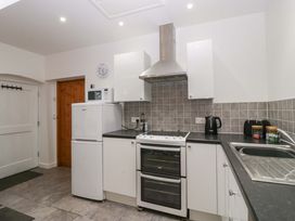 A kitchen with appliances and cabinets at Castle Rag in Lydney