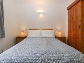 A bedroom with a bed and nightstands at Castle Rag in Lydney