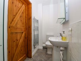 A bathroom with a wash basin and towel radiator at Castle Rag in Lydney