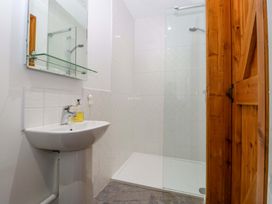 A bathroom with a wash basin and shower at Castle Rag in Lydney